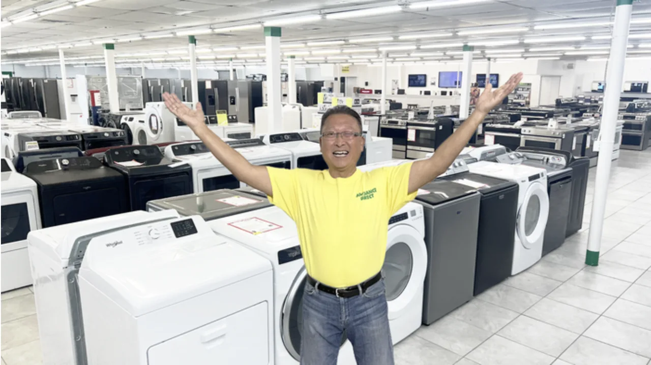 Sam at Appliance Direct showroom - rows of new washers, dryers, and refrigerators in stock